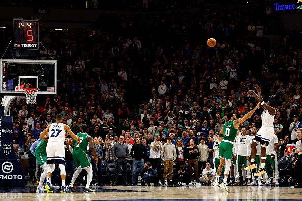 MINNEAPOLIS, MINNESOTA - NOVEMBER 06: Anthony Edwards #5 of the Minnesota Timberwolves shoots the ball while Jayson Tatum #0 of the Boston Celtics defends in the fourth quarter at Target Center on November 06, 2023 in Minneapolis, Minnesota. The Timberwolves defeated the Celtics 114-109 in overtime. NOTE TO USER: User expressly acknowledges and agrees that, by downloading and or using this photograph, User is consenting to the terms and conditions of the Getty Images License Agreement. (Photo by David Berding/Getty Images)