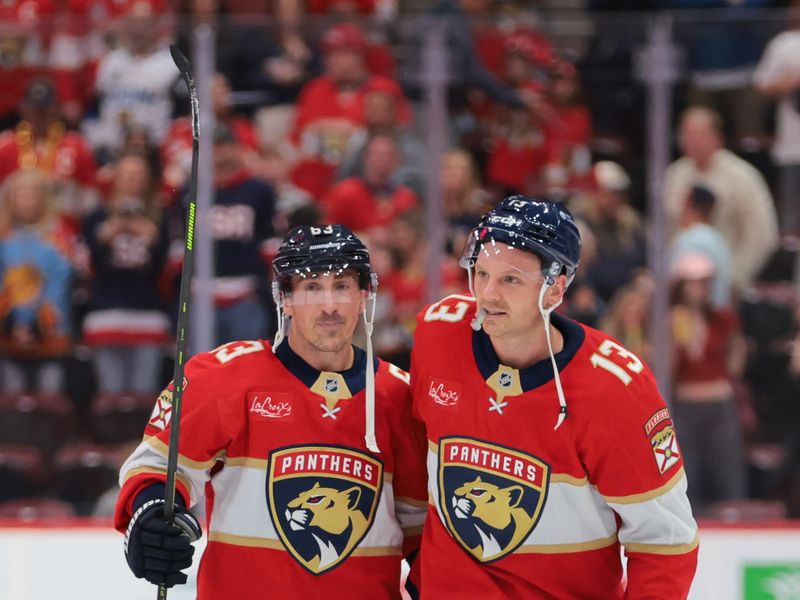 Nov 1, 2025; Sunrise, Florida, USA; Florida Panthers left wing Brad Marchand (63) and center Sam Reinhart (13) celebrate after the game against the Dallas Stars at Amerant Bank Arena. Mandatory Credit: Sam Navarro-Imagn Images