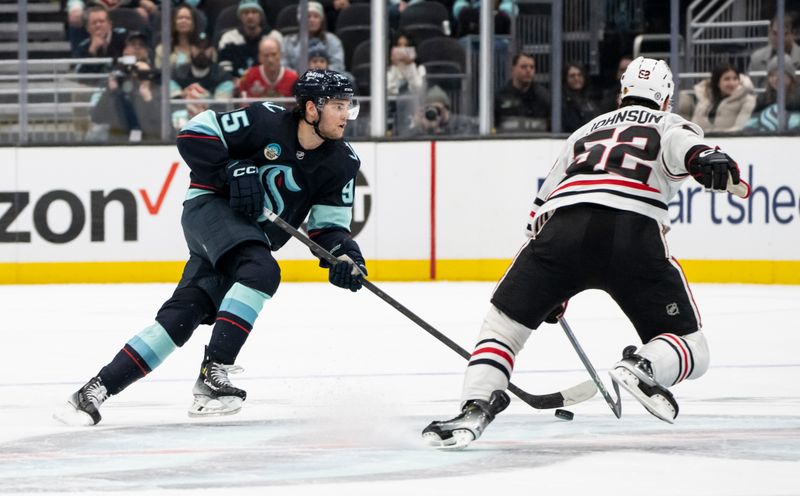 Jan 24, 2024; Seattle, Washington, USA; Seattle Kraken forward Andre Burakovsky (95) skates against Chicago Blackhawks forward Reese Johnson (52) during the third period at Climate Pledge Arena. Mandatory Credit: Stephen Brashear-USA TODAY Sports