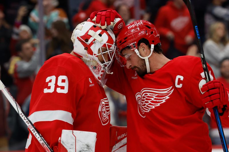 Oct 24, 2024; Detroit, Michigan, USA;  Detroit Red Wings goaltender Cam Talbot (39) and center Dylan Larkin (71) celebrate after defeating the New Jersey Devils at Little Caesars Arena. Mandatory Credit: Rick Osentoski-Imagn Images