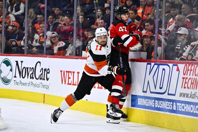 Apr 13, 2024; Philadelphia, Pennsylvania, USA; Philadelphia Flyers right wing Travis Konecny (11) hits New Jersey Devils defenseman Luke Hughes (43) in the first period at Wells Fargo Center. Mandatory Credit: Kyle Ross-USA TODAY Sports