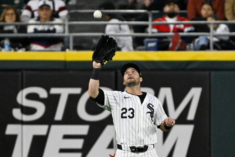 May 11, 2024; Chicago, Illinois, USA;  Chicago White Sox outfielder Andrew Benintendi (23) catches a fly ball to retire Cleveland Guardians second base Andrés Giménez (not pictured) during the eighth inning at Guaranteed Rate Field. Mandatory Credit: Matt Marton-USA TODAY Sports