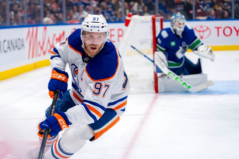 Oct 4, 2024; Vancouver, British Columbia, CAN; Edmonton Oilers forward Connor McDavid (97) handles the puck against the Vancouver Canucks during the second period at Rogers Arena. Mandatory Credit: Bob Frid-Imagn Images