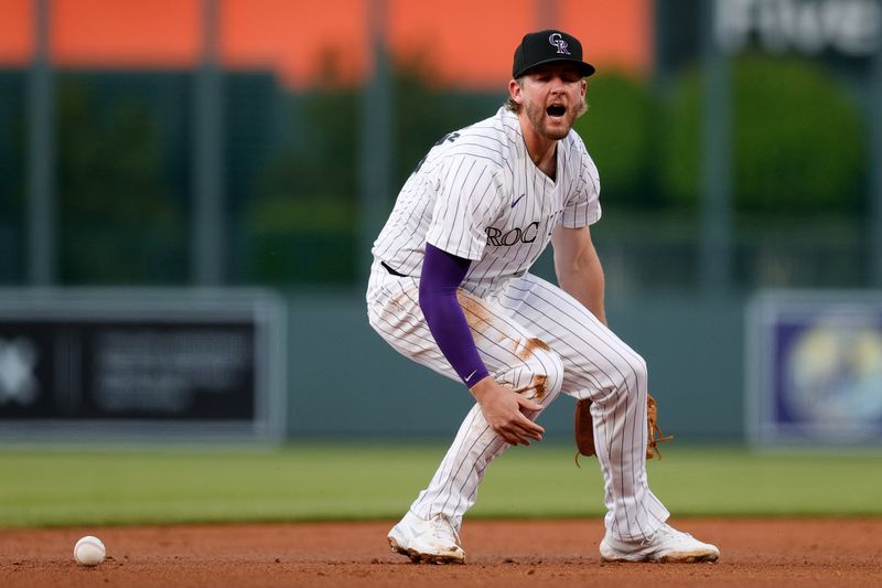 Apr 24, 2024; Denver, Colorado, USA; Colorado Rockies third baseman Ryan McMahon (24) reacts after dropping the ball on a play in the second inning against the San Diego Padres at Coors Field. Mandatory Credit: Isaiah J. Downing-USA TODAY Sports