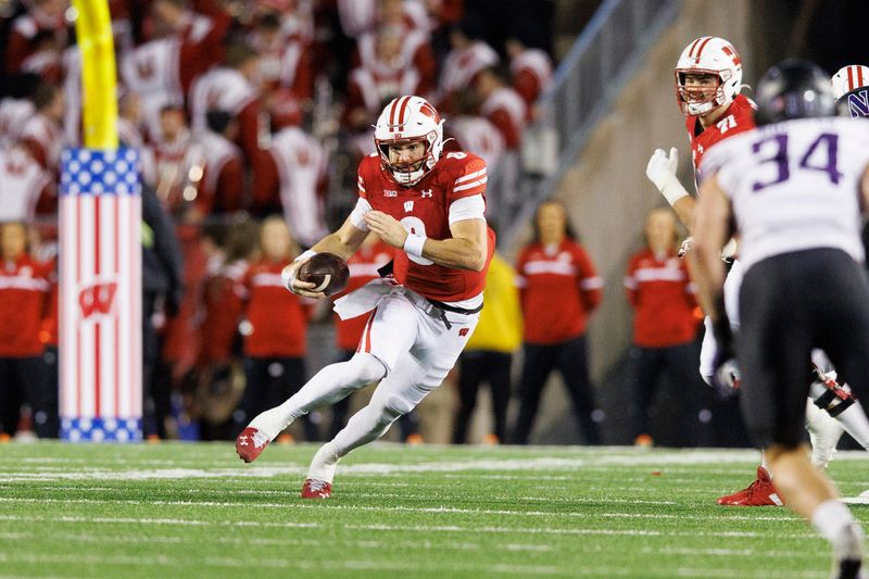 Nov 11, 2023; Madison, Wisconsin, USA;  Wisconsin Badgers quarterback Tanner Mordecai (8) rushes with the football during the fourth quarter against the Northwestern Wildcats at Camp Randall Stadium. Mandatory Credit: Jeff Hanisch-USA TODAY Sports