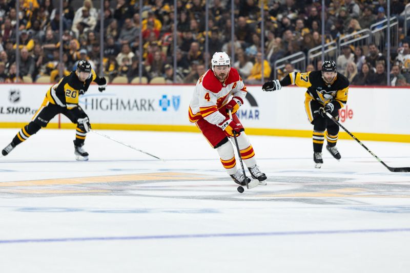 Oct 14, 2023; Pittsburgh, Pennsylvania, USA; Calgary Flames defenseman Rasmus Andersson (4) skates the puck down ice against the Pittsburgh Penguins during the second period at PPG Paints Arena. Mandatory Credit: Scott Galvin-USA TODAY Sports