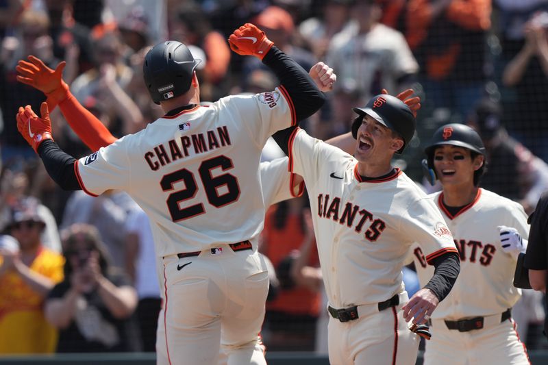 May 3, 2025; San Francisco, California, USA; San Francisco Giants third baseman Matt Chapman (26) is congratulated by right fielder Mike Yastrzemski (center right) after hitting a grand slam home run against the Colorado Rockies during the sixth inning at Oracle Park. Mandatory Credit: Darren Yamashita-Imagn Images