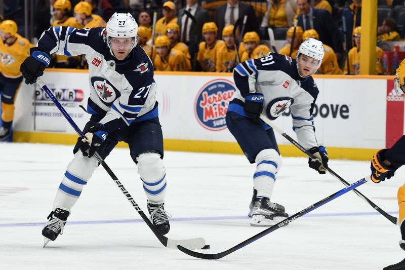 Nov 26, 2023; Nashville, Tennessee, USA; Winnipeg Jets left wing Nikolaj Ehlers (27) drops a pass to center Cole Perfetti (91) during the second period against the Nashville Predators at Bridgestone Arena. Mandatory Credit: Christopher Hanewinckel-USA TODAY Sports