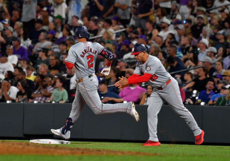 Jun 22, 2024; Denver, Colorado, USA; Washington Nationals first base coach Gerardo Parra (88) claps his hands as second baseman Luis Garcia Jr. (2) rounds first base after hitting a home run against the Colorado Rockies in the eighth inning at Coors Field. Mandatory Credit: John Leyba-USA TODAY Sports