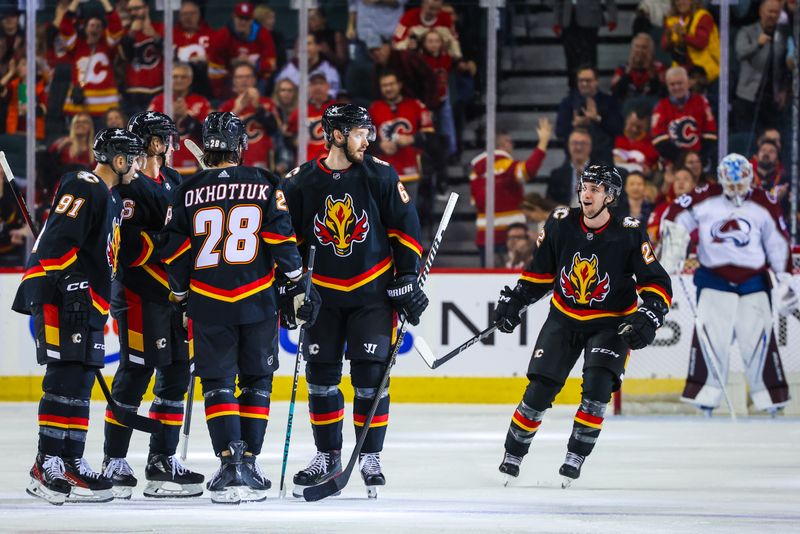 Mar 12, 2024; Calgary, Alberta, CAN; Calgary Flames defenseman Daniil Miromanov (62) celebrates his goal with teammates against the Colorado Avalanche during the first period at Scotiabank Saddledome. Mandatory Credit: Sergei Belski-USA TODAY Sports