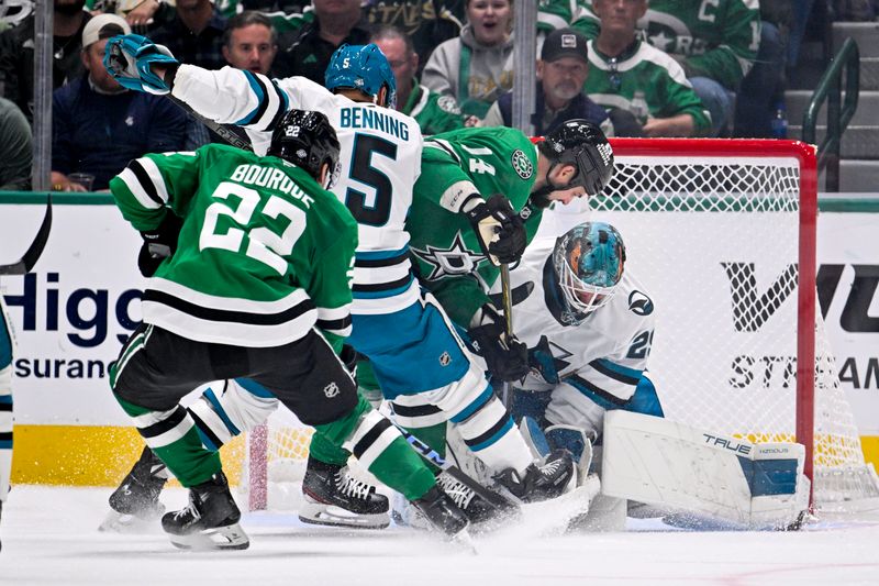 Oct 15, 2024; Dallas, Texas, USA; Dallas Stars center Mavrik Bourque (22) and left wing Jamie Benn (14) and defenseman Matt Benning (5) and goaltender Mackenzie Blackwood (29) look for the puck in the Sharks crease during the third period at the American Airlines Center. Mandatory Credit: Jerome Miron-Imagn Images