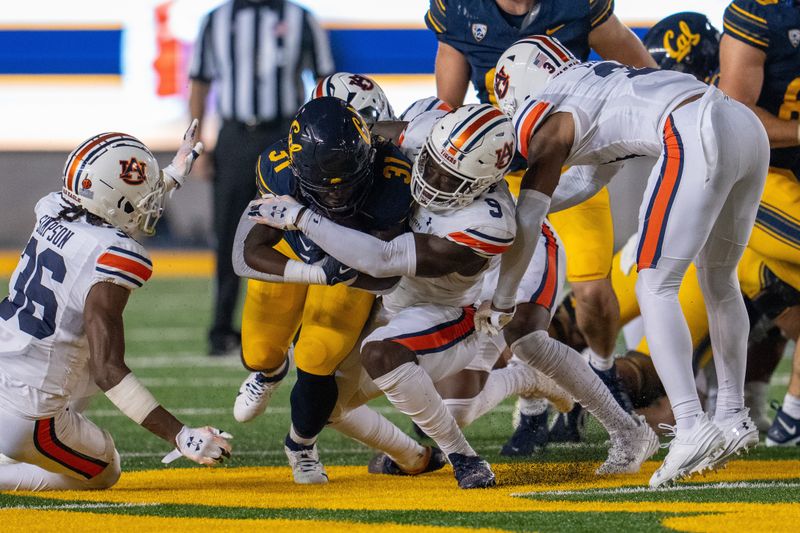 Sep 9, 2023; Berkeley, California, USA; California Golden Bears running back Ashton Stredick (31) rushes for a first down against Auburn Tigers linebacker Eugene Asante (9) during the third quarter at California Memorial Stadium. Mandatory Credit: Neville E. Guard-USA TODAY Sports