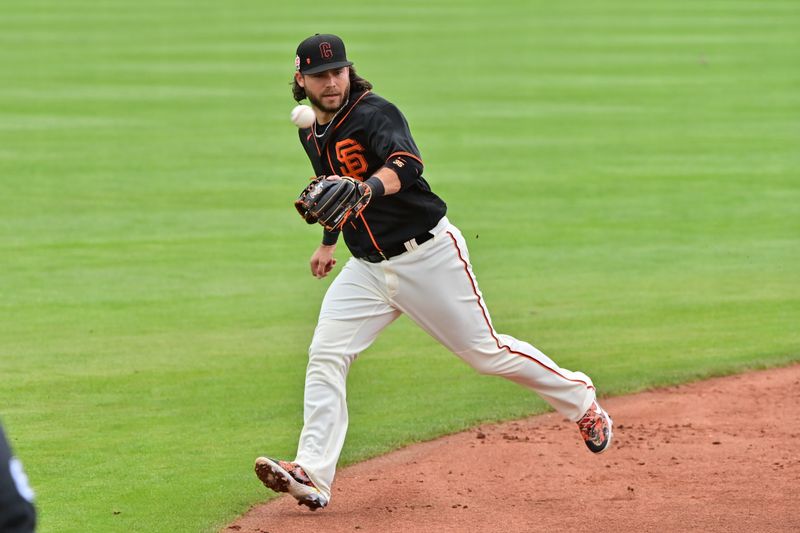 Mar 22, 2023; Scottsdale, Arizona, USA; A batted ball flies past San Francisco Giants shortstop Brandon Crawford (35) follows the ball in the third inning against the Texas Rangers during a Spring Training game at Scottsdale Stadium. Mandatory Credit: Matt Kartozian-USA TODAY Sports