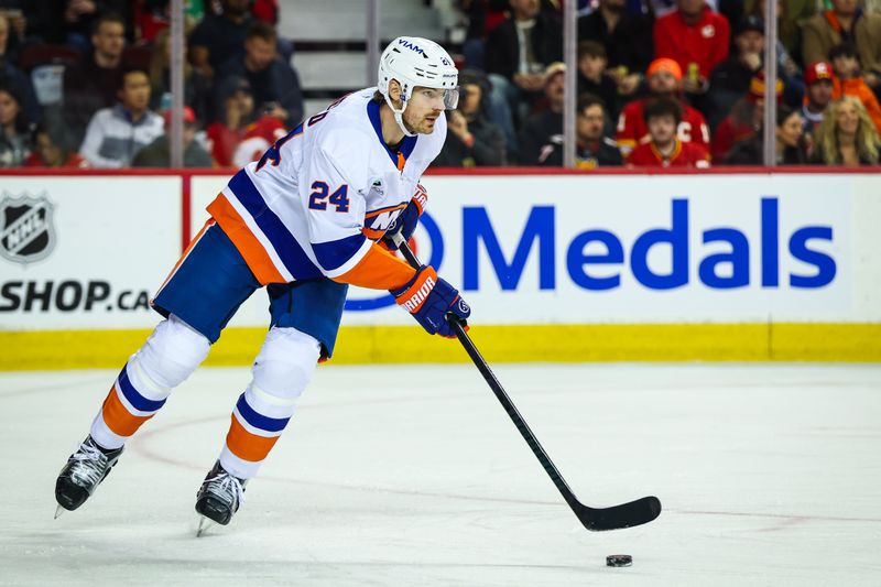 Jan 17, 2026; Calgary, Alberta, CAN; New York Islanders defenseman Scott Mayfield (24) skates with the puck against the Calgary Flames during the second period at Scotiabank Saddledome. Mandatory Credit: Sergei Belski-Imagn Images