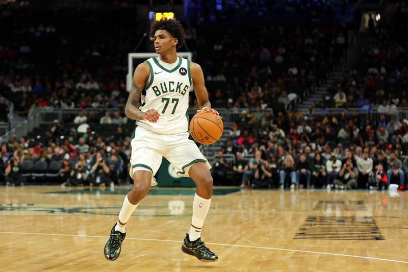 MILWAUKEE, WISCONSIN - OCTOBER 14: AJ Johnson #77 of the Milwaukee Bucks handles the ball during the second half of a preseason game against the Chicago Bulls at Fiserv Forum on October 14, 2024 in Milwaukee, Wisconsin.  NOTE TO USER: User expressly acknowledges and agrees that, by downloading and or using this photograph, User is consenting to the terms and conditions of the Getty Images License Agreement. (Photo by Stacy Revere/Getty Images)