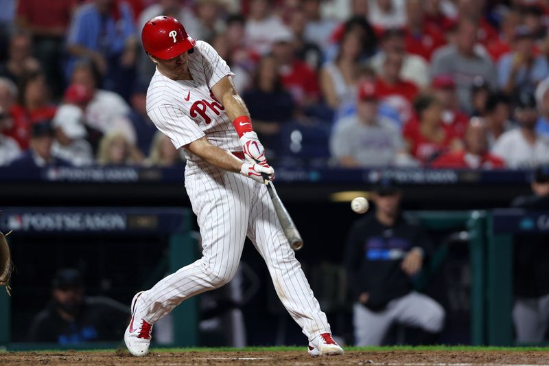 Oct 3, 2023; Philadelphia, Pennsylvania, USA; Philadelphia Phillies catcher J.T. Realmuto (10) hits a single in the fourth inning against the Miami Marlins for game one of the Wildcard series for the 2023 MLB playoffs at Citizens Bank Park. Mandatory Credit: Bill Streicher-USA TODAY Sports