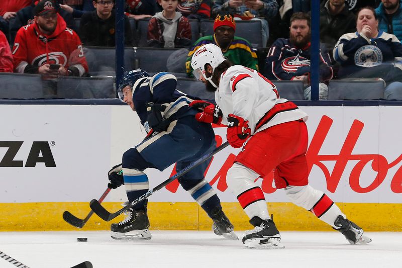 Feb 29, 2024; Columbus, Ohio, USA; Columbus Blue Jackets right wing Mathieu Olivier (24) and Carolina Hurricanes defenseman Jalen Chatfield (5) battle for a loose puck during the first period at Nationwide Arena. Mandatory Credit: Russell LaBounty-USA TODAY Sports