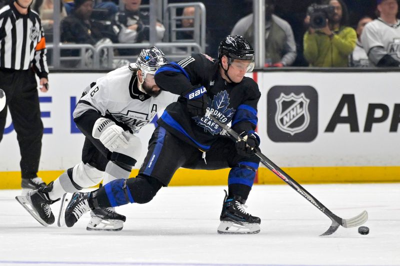 Jan 2, 2024; Los Angeles, California, USA; Los Angeles Kings defenseman Drew Doughty (8) chases down Toronto Maple Leafs center Max Domi (11) in the second period at Crypto.com Arena. Mandatory Credit: Jayne Kamin-Oncea-USA TODAY Sports