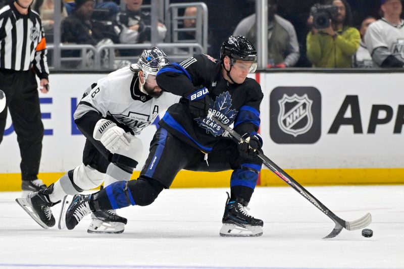 Jan 2, 2024; Los Angeles, California, USA; Los Angeles Kings defenseman Drew Doughty (8) chases down Toronto Maple Leafs center Max Domi (11) in the second period at Crypto.com Arena. Mandatory Credit: Jayne Kamin-Oncea-USA TODAY Sports