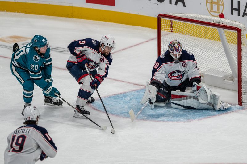 Nov 5, 2024; San Jose, California, USA;  Columbus Blue Jackets goaltender Elvis Merzlikins (90) makes a save on the deflected shot on goal by San Jose Sharks left wing Fabian Zetterlund (20) during the third period at SAP Center at San Jose. Mandatory Credit: Neville E. Guard-Imagn Images