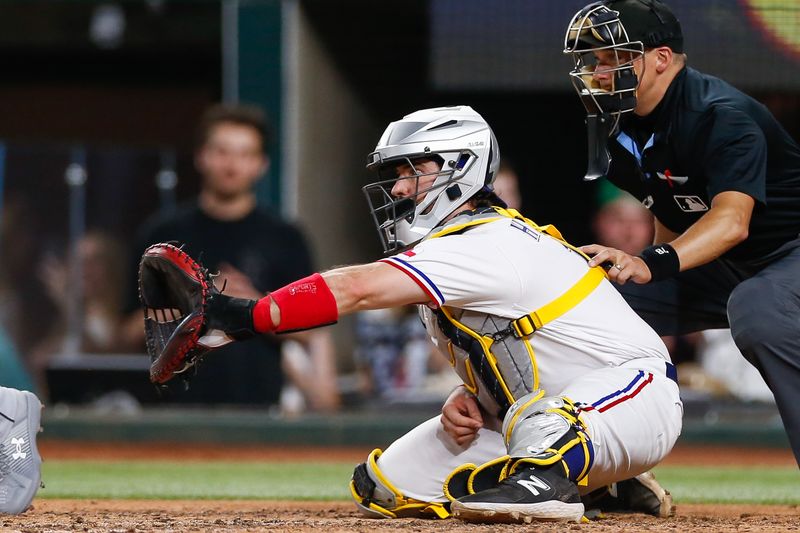 Aug 2, 2023; Arlington, Texas, USA; Texas Rangers catcher Austin Hedges (11) catches during the ninth inning against the Chicago White Sox at Globe Life Field. Mandatory Credit: Andrew Dieb-USA TODAY Sports