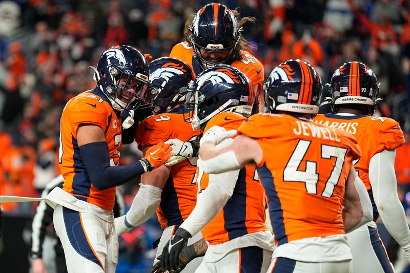 Members of the Denver Broncos celebrate after teammate Zach Allen (99) sacked Cleveland Browns quarterback PJ Walker in the end zone for a safety during the second half of an NFL football game on Sunday, Nov. 26, 2023, in Denver. (AP Photo/Jack Dempsey)