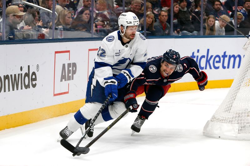 Oct 18, 2025; Columbus, Ohio, USA; Columbus Blue Jackets defenseman Denton Mateychuk (5) challenges Tampa Bay Lightning right wing Oliver Bjorkstrand (22) for the puck during the first period at Nationwide Arena. Mandatory Credit: Russell LaBounty-Imagn Images
