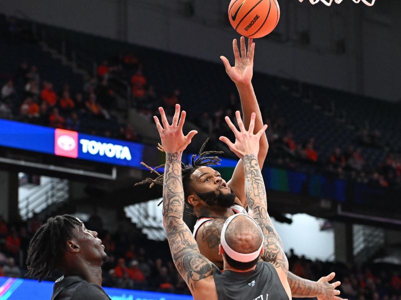Jan 7, 2025; Syracuse, New York, USA; Syracuse Orange center Eddie Lampkin Jr. (44) shoots the ball as Georgia Tech Yellow Jackets forward Duncan Powell (31) and forward Baye Ndongo (11) defend in the second half at the JMA Wireless Dome. Mandatory Credit: Mark Konezny-Imagn Images