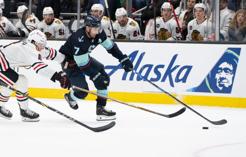 Jan 24, 2024; Seattle, Washington, USA; Seattle Kraken forward Jordan Eberle (7) skates against Chicago Blackhawks forward Ryan Donato (8) during the first period at Climate Pledge Arena. Mandatory Credit: Stephen Brashear-USA TODAY Sports