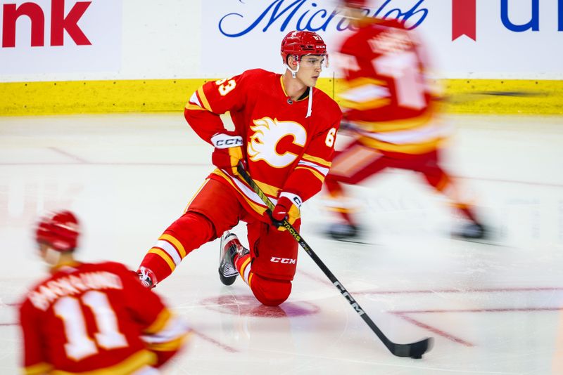 Oct 11, 2023; Calgary, Alberta, CAN; Calgary Flames center Adam Ruzicka (63) controls the puck during the warmup period against the Winnipeg Jets at Scotiabank Saddledome. Mandatory Credit: Sergei Belski-USA TODAY Sports