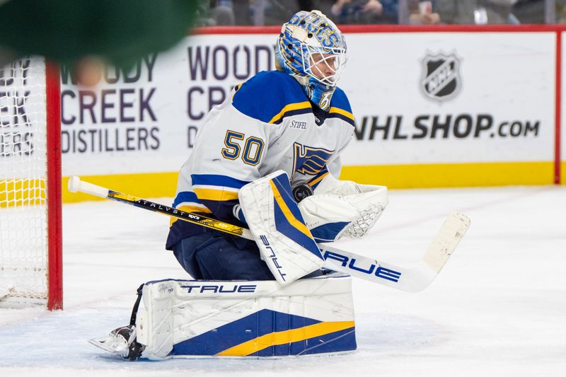 Jan 7, 2025; Saint Paul, Minnesota, USA; St. Louis Blues goaltender Jordan Binnington (50) makes a save against the Minnesota Wild in the second period at Xcel Energy Center. Mandatory Credit: Matt Blewett-Imagn Images