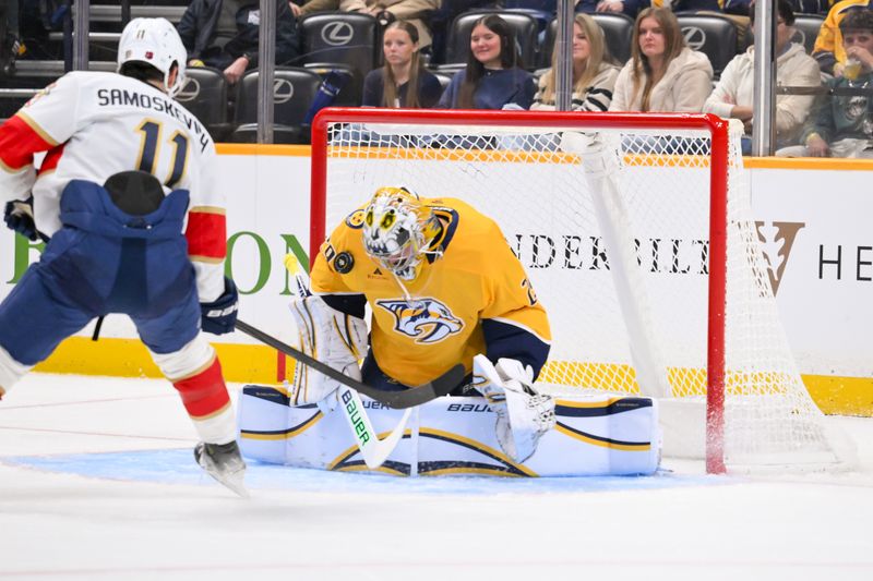 Nov 24, 2025; Nashville, Tennessee, USA;  Nashville Predators goaltender Justus Annunen (29) blocks the shot of Florida Panthers right wing Mackie Samoskevich (11) during the second period at Bridgestone Arena. Mandatory Credit: Steve Roberts-Imagn Images