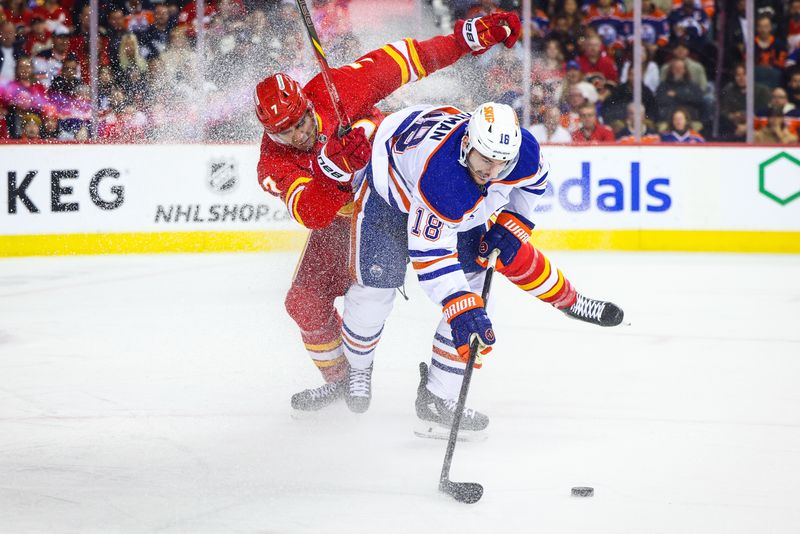 Nov 3, 2024; Calgary, Alberta, CAN; Edmonton Oilers left wing Zach Hyman (18) and Calgary Flames defenseman Kevin Bahl (7) battles for the puck during the first period at Scotiabank Saddledome. Mandatory Credit: Sergei Belski-Imagn Images
