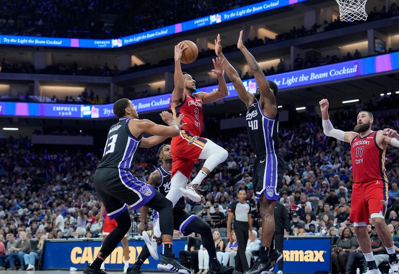 SACRAMENTO, CALIFORNIA - APRIL 11: CJ McCollum #3 of the New Orleans Pelicans drives to the basket against Harrison Barnes #40 of the Sacramento Kings during the first half of an NBA game at Golden 1 Center on April 11, 2024 in Sacramento, California. NOTE TO USER: User expressly acknowledges and agrees that, by downloading and or using this photograph, User is consenting to the terms and conditions of the Getty Images License Agreement. (Photo by Thearon W. Henderson/Getty Images)