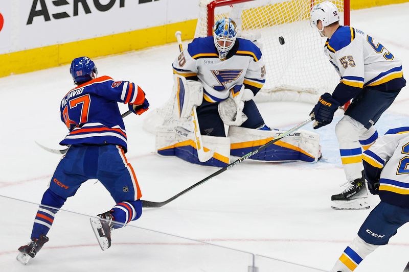 Feb 28, 2024; Edmonton, Alberta, CAN; Edmonton Oilers forward Connor McDavid (97) scores the game wining goal during overtime against St. Louis Blues goaltender Jordan Binnington (50) at Rogers Place. Mandatory Credit: Perry Nelson-USA TODAY Sports