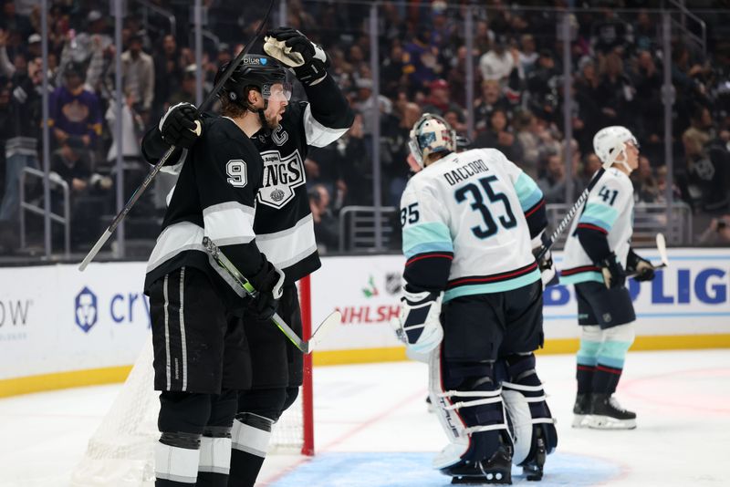 Nov 23, 2024; Los Angeles, California, USA;  Los Angeles Kings right wing Adrian Kempe (9) celebrates with center Anze Kopitar (11) after scoring a goal during the second period against the Seattle Kraken at Crypto.com Arena. Mandatory Credit: Kiyoshi Mio-Imagn Images