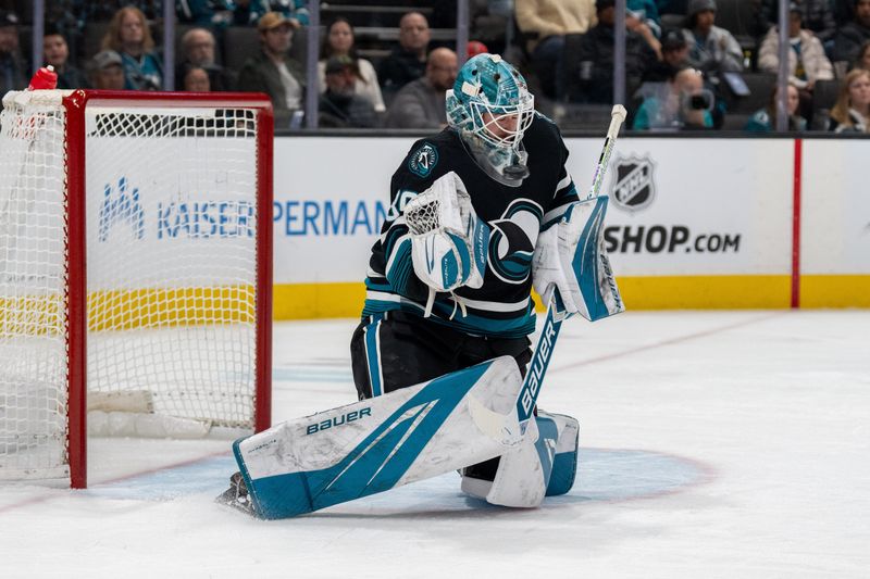 Jan 23, 2025; San Jose, California, USA;  San Jose Sharks goaltender Yaroslav Askarov (30) makes a save against the Nashville Predators during the first period at SAP Center at San Jose. Mandatory Credit: Neville E. Guard-Imagn Images