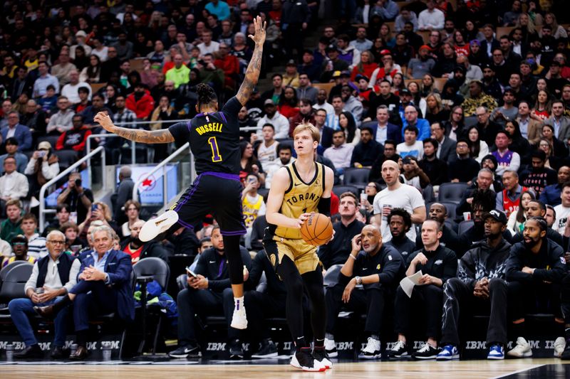 TORONTO, CANADA - APRIL 2: Gradey Dick #1 of the Toronto Raptors looks to shoot against D'Angelo Russell #1 of the Los Angeles Lakers in the second half at Scotiabank Arena on April 2, 2024 in Toronto, Canada. NOTE TO USER: User expressly acknowledges and agrees that, by downloading and or using this photograph, User is consenting to the terms and conditions of the Getty Images License Agreement. (Photo by Cole Burston/Getty Images)