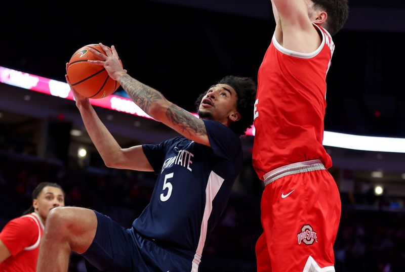 Jan 26, 2026; Columbus, Ohio, USA; Penn State Nittany Lions guard Freddie Dilione V. (5) drives to the basket as Ohio State Buckeyes center Ivan Njegovan (7) defends during the first half at Value City Arena. Mandatory Credit: Joseph Maiorana-Imagn Images