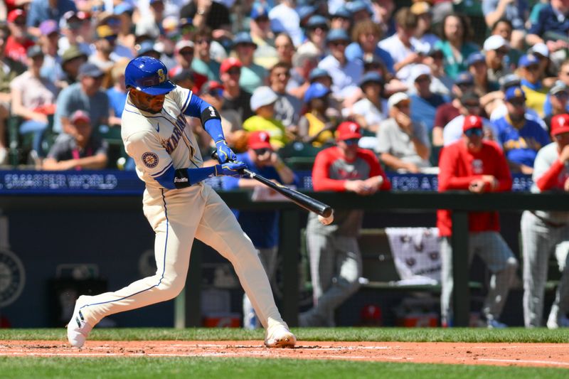 Aug 4, 2024; Seattle, Washington, USA; Seattle Mariners center fielder Victor Robles (10) hits a single against the Philadelphia Phillies during the third inning at T-Mobile Park. Mandatory Credit: Steven Bisig-USA TODAY Sports