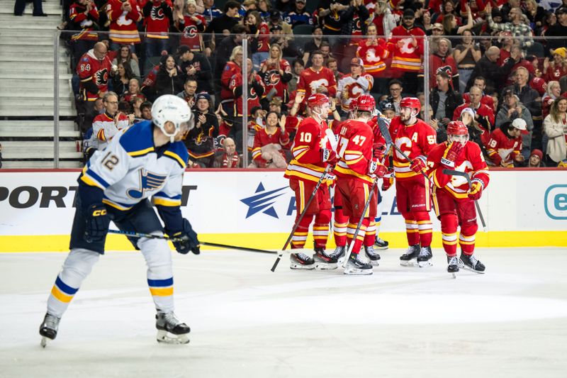 Dec 5, 2024; Calgary, Alberta, CAN; Calgary Flames right wing Matt Coronato (27) celebrates with Calgary Flames center Jonathan Huberdeau (10), center Connor Zary (47) and teammates after scoring a goal against the St. Louis Blues during the second period at Scotiabank Saddledome. Mandatory Credit: Brett Holmes-Imagn Images