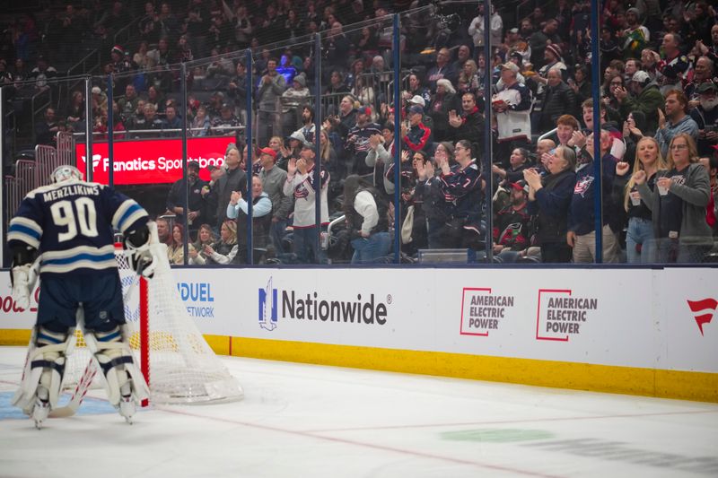 Nov 23, 2024; Columbus, Ohio, USA;  Fans celebrate a goal scored by Columbus Blue Jackets defenseman Dante Fabbro in the game against the Carolina Hurricanes in the first period at Nationwide Arena. Mandatory Credit: Aaron Doster-Imagn Images