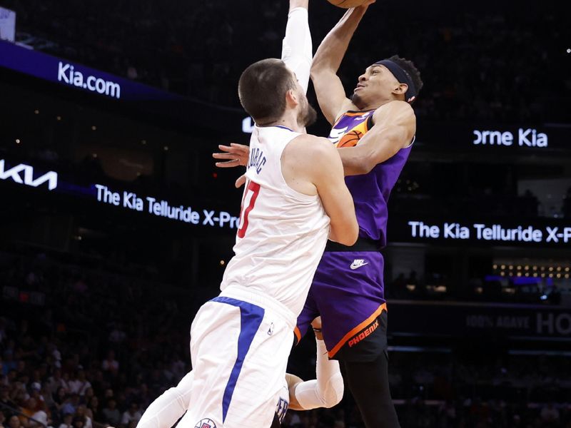 PHOENIX, ARIZONA - APRIL 09: Darius Bazley #55 of the Phoenix Suns dunks over Ivica Zubac #40 of the Los Angeles Clippers during the first half of the game at Footprint Center on April 09, 2023 in Phoenix, Arizona. NOTE TO USER: User expressly acknowledges and agrees that, by downloading and or using this photograph, User is consenting to the terms and conditions of the Getty Images License Agreement.  (Photo by Chris Coduto/Getty Images)