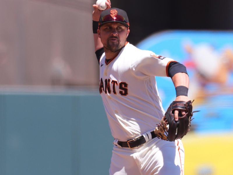 Aug 16, 2023; San Francisco, California, USA; San Francisco Giants third baseman J.D. Davis (7) throws to first base during the fourth inning against the Tampa Bay Rays at Oracle Park. Mandatory Credit: Sergio Estrada-USA TODAY Sports