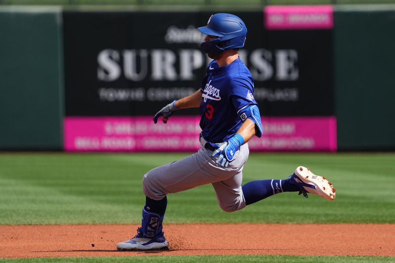 Feb 28, 2024; Surprise, Arizona, USA; Los Angeles Dodgers shortstop Chris Taylor (3) slides into second base against the Texas Rangers during the first inning at Surprise Stadium. Mandatory Credit: Joe Camporeale-USA TODAY Sports