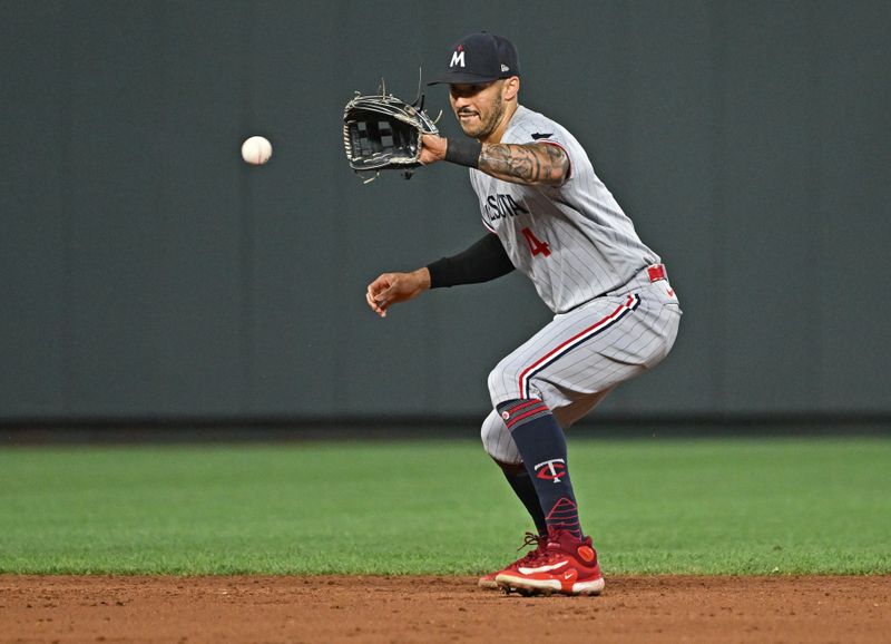 Jul 29, 2023; Kansas City, Missouri, USA;  Minnesota Twins shortstop Carlos Correa (4) fields the ball against the Kansas City Royals during the eighth inning at Kauffman Stadium. Mandatory Credit: Peter Aiken-USA TODAY Sports