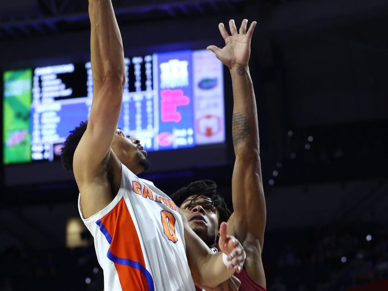 Jan 25, 2023; Gainesville, Florida, USA; Florida Gators guard Myreon Jones (0) shoots over South Carolina Gamecocks forward Daniel Hankins-Sanford (30) during the second half at Exactech Arena at the Stephen C. O'Connell Center. Mandatory Credit: Kim Klement-USA TODAY Sports