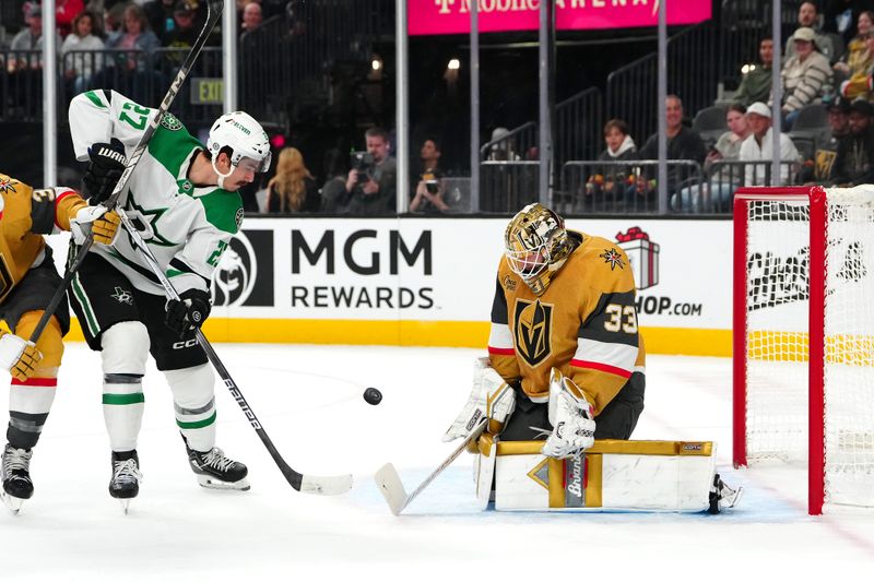 Dec 6, 2024; Las Vegas, Nevada, USA; Vegas Golden Knights goaltender Adin Hill (33) makes a save as Dallas Stars left wing Mason Marchment (27) looks for a rebound during the first period at T-Mobile Arena. Mandatory Credit: Stephen R. Sylvanie-Imagn Images