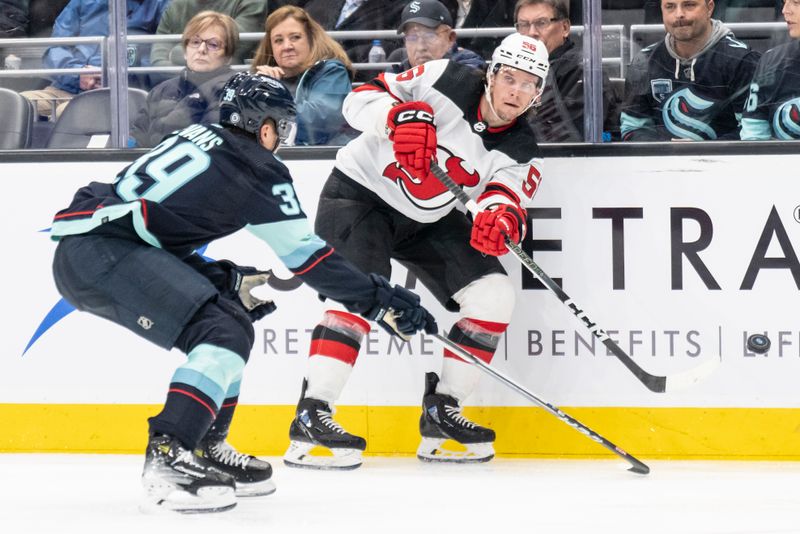 Dec 7, 2023; Seattle, Washington, USA; New Jersey Devils forward Erik Haula (56) passes the puck against Seattle Kraken defensman Ryker Evans (39) during the third period at Climate Pledge Arena. Mandatory Credit: Stephen Brashear-USA TODAY Sports