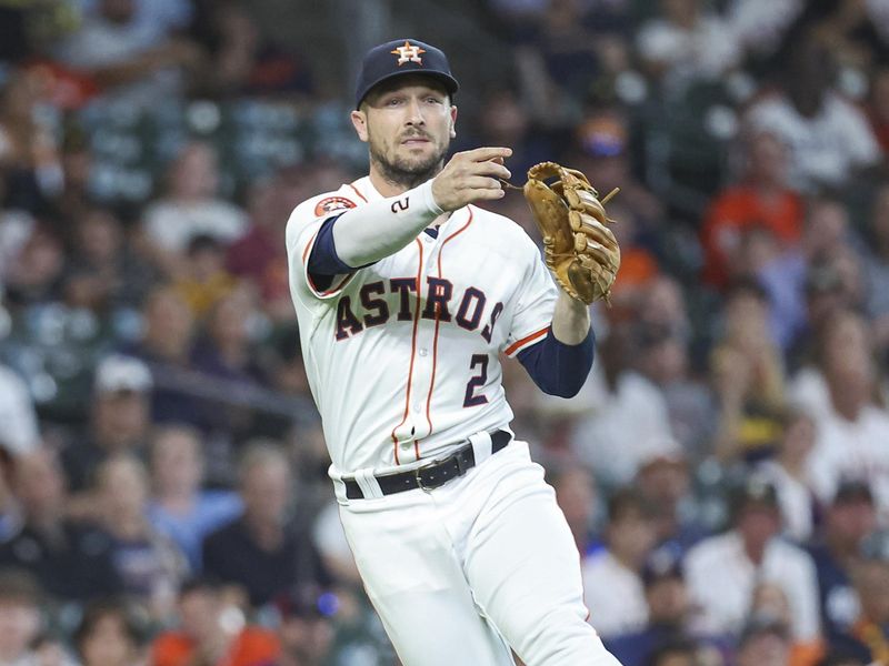 Jul 30, 2024; Houston, Texas, USA; Houston Astros third baseman Alex Bregman (2) throws out a runner during the first inning against the Pittsburgh Pirates at Minute Maid Park. Mandatory Credit: Troy Taormina-USA TODAY Sports
